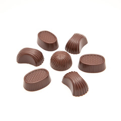 Delicious flower formed from various chocolate candies on white