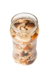 Mushrooms in a glass jar over a white background