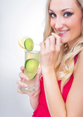 Young woman drinking lemonade, studio-shot