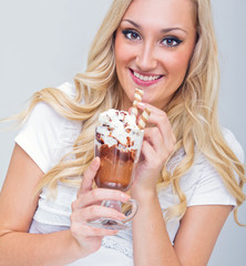 Young woman drinking ice coffe, studio-shot