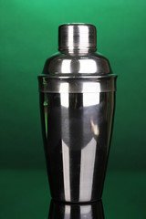 Cocktail shaker on green background