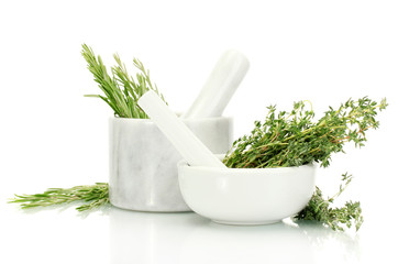 mortars with fresh green thyme and rosemary isolated on white