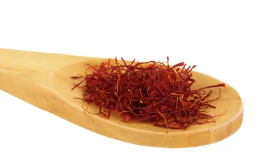Türaufkleber stigmas of saffron in wooden spoon on white background close-up © Africa Studio