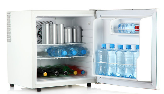 mini fridge full of bottles and jars with various drinks
