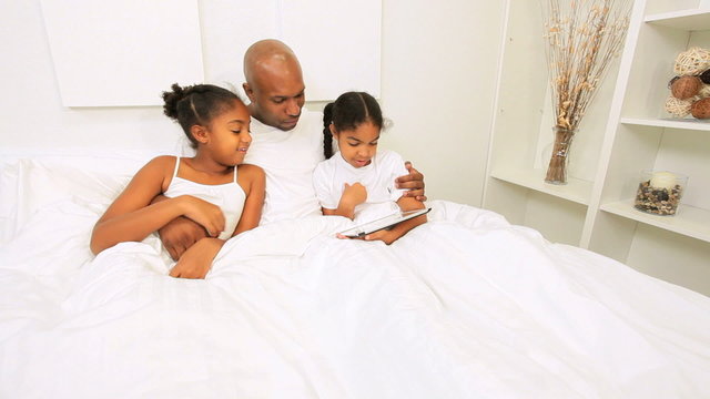 African American Children Father Playing Bed Wireless Technology