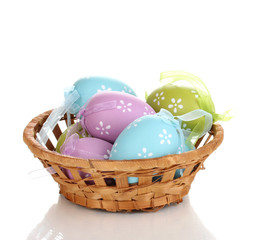 Colorful easter eggs in basket isolated on white