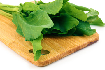 Fresh sorrel on wooden board isolated on white