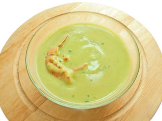spinach cream soup with shrimp on the desk over white