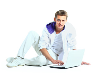 Man with arms raised using laptop