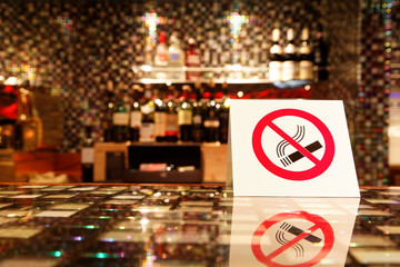 NO SMOKING sign on the bar.