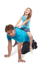 Father and little daughter play horse-ride