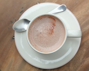 Hot chocolate in a white cup on table