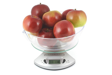 red apples weighed on a kitchen scale