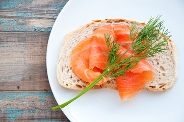 Smoked salmon on sourdough bread garnished with fresh dill.