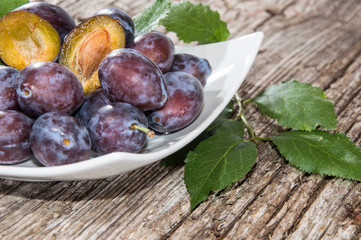 Heap of Plums in a bowl (side view)