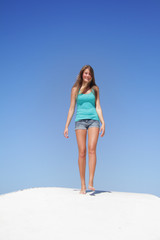 young happy woman walking isolated over blue sky