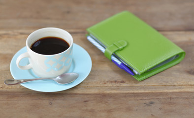 Fototapeta na wymiar coffee cup with notebook on table