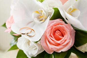 Gold wedding rings on flower