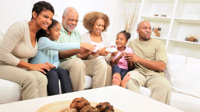 African American Family Playing Games Console