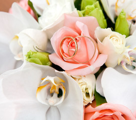 Gold wedding rings on flower