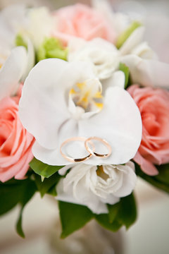 Gold wedding rings on flower