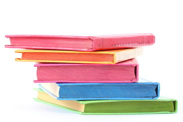 stack of bright books over white