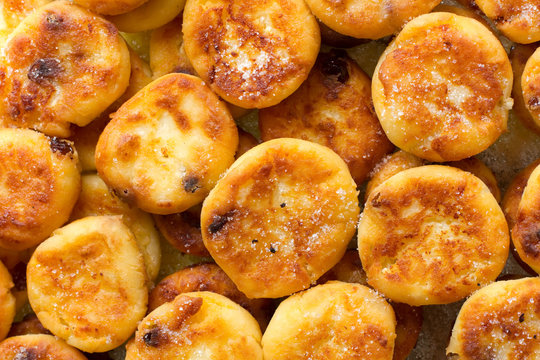 Homemade sweet cheese pancakes with raisins background