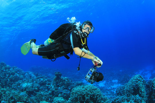 Female Scuba Diver explores coral reef
