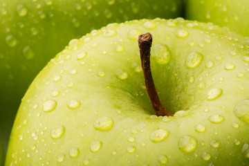 Closeup of a green Granny Smith Apple with water droplets
