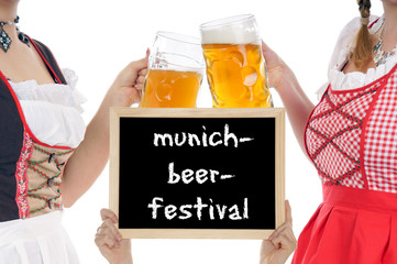 Two young pretty women in dirndl with beer mug