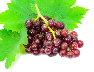 Red grapes with fresh leaves, isolated on white background.
