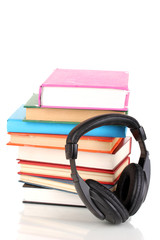 Headphones on books isolated on white