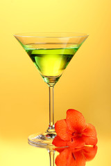 glass with cocktail and gladiolus bud