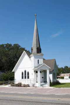 Very small rural christian church with a steeple