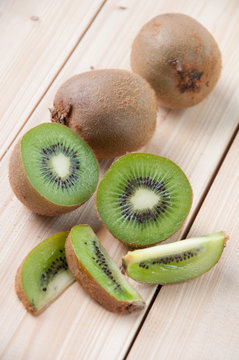 Fresh organic kiwi and his segments on wooden boards