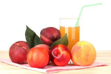 Ripe peaches and juice on wooden table on white background
