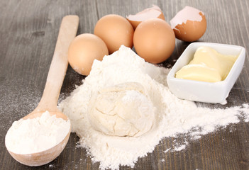 Eggs, flour and butter close-up on wooden table