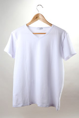 white t-shirt on hanger isolated on white