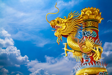 Golden gragon statue on blue sky 