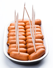 cocktail sausages; punctured tray with chopsticks