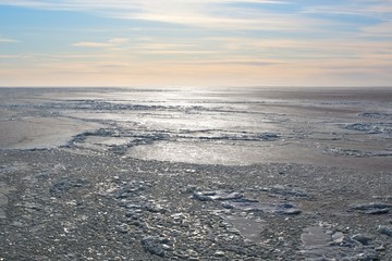 Photo of backlit sea covered with ice