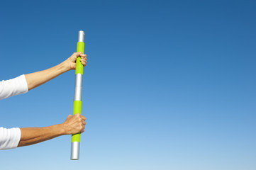 Hands holding weight sky background