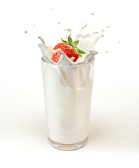 Strawberry falling into a glass of milk creating a splash.