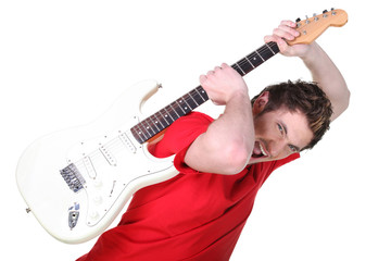 Aggressive young man about to smash his guitar