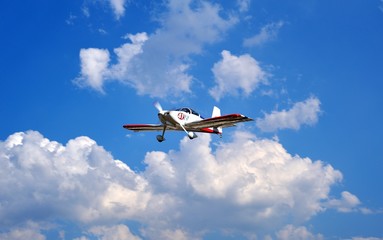 Fototapeta na wymiar experimental Airplane in the blue sky with clouds