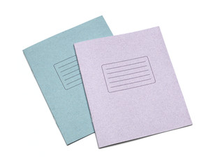 multicolored exercise books over the white background