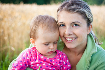 Portrait of a mother and her baby girl outdoors