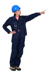 Woman construction worker showing something