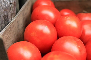 some red tomatoes in wooden box