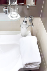 Faucet with soap dispenser in bathroom.